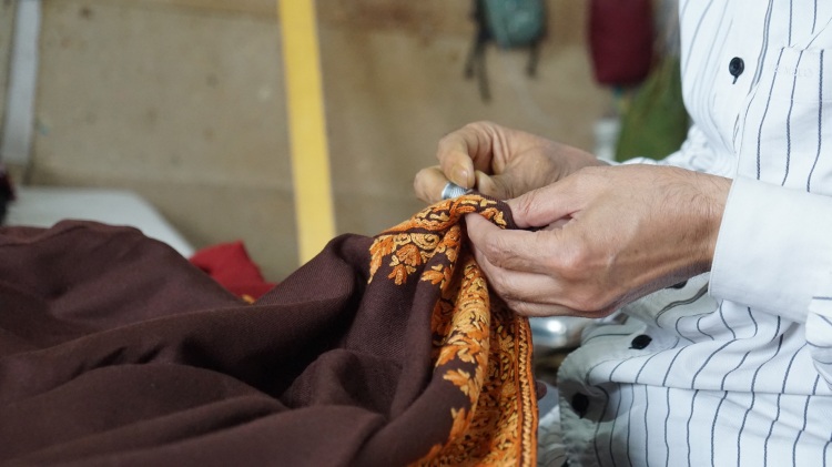 Skilled artisan handcrafting pashmina shawl